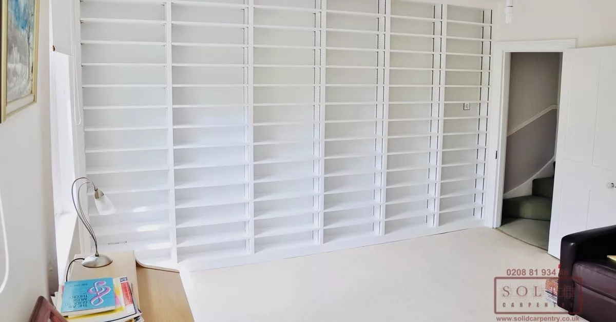 Empty room with white bookcases