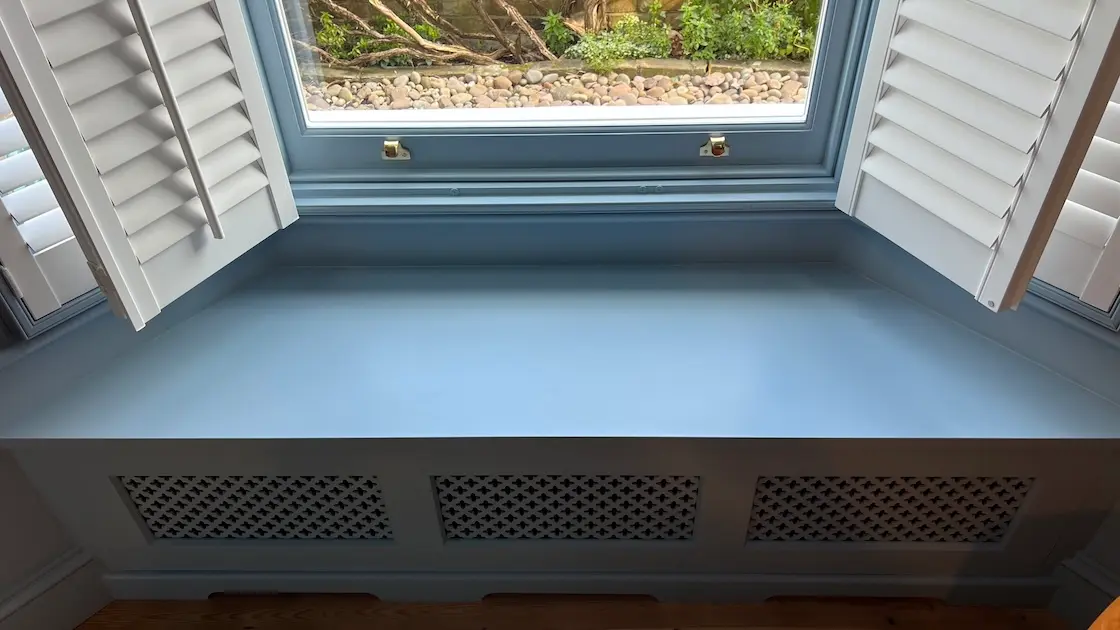 blue window seat with ventilation grill
