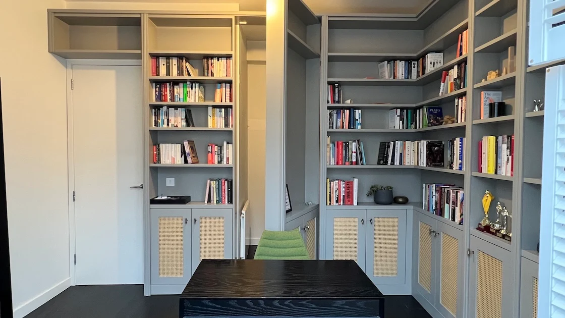 Modern study with bookshelves and desk.