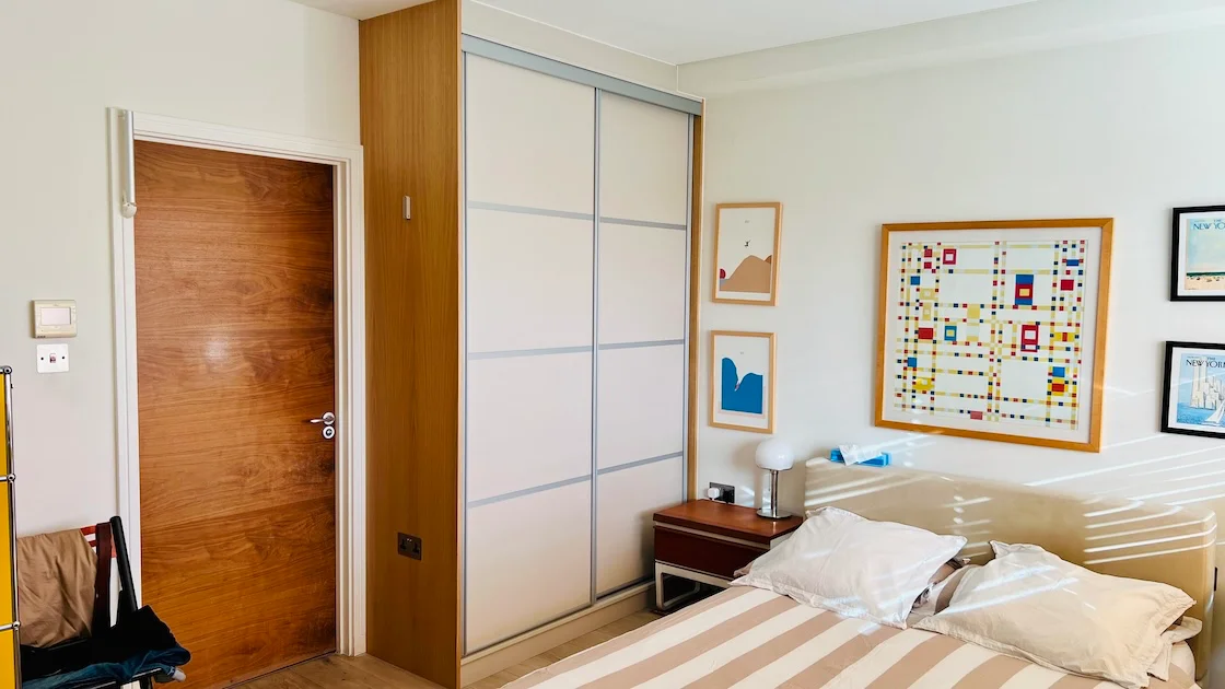 Modern bedroom with sliding wardrobe doors.