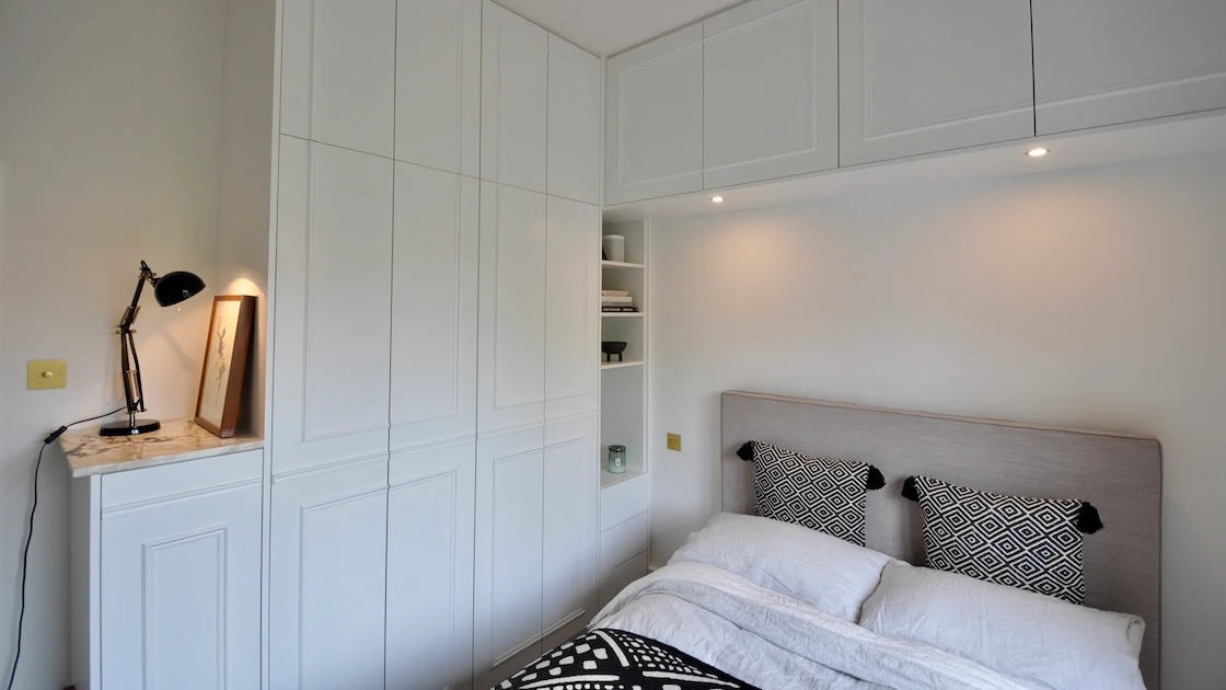 Modern bedroom with sleek wardrobe storage solutions.